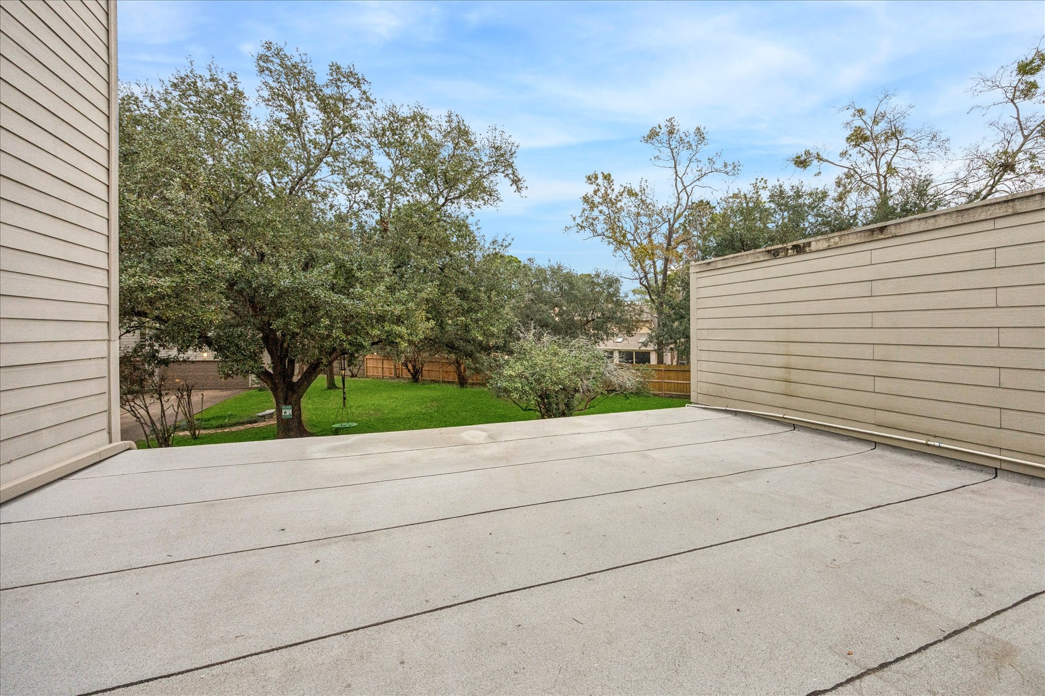 1615 Prairie Mark Lane Houston, TX 77077 - Photo 20 of 25 And a view of the rooftop deck that needs finished. It overlooks this great little green grassy area with beautiful trees. And, it faces East ... so no sun in your face in the evenings. The deck is 24' x 20' (as is the garage).