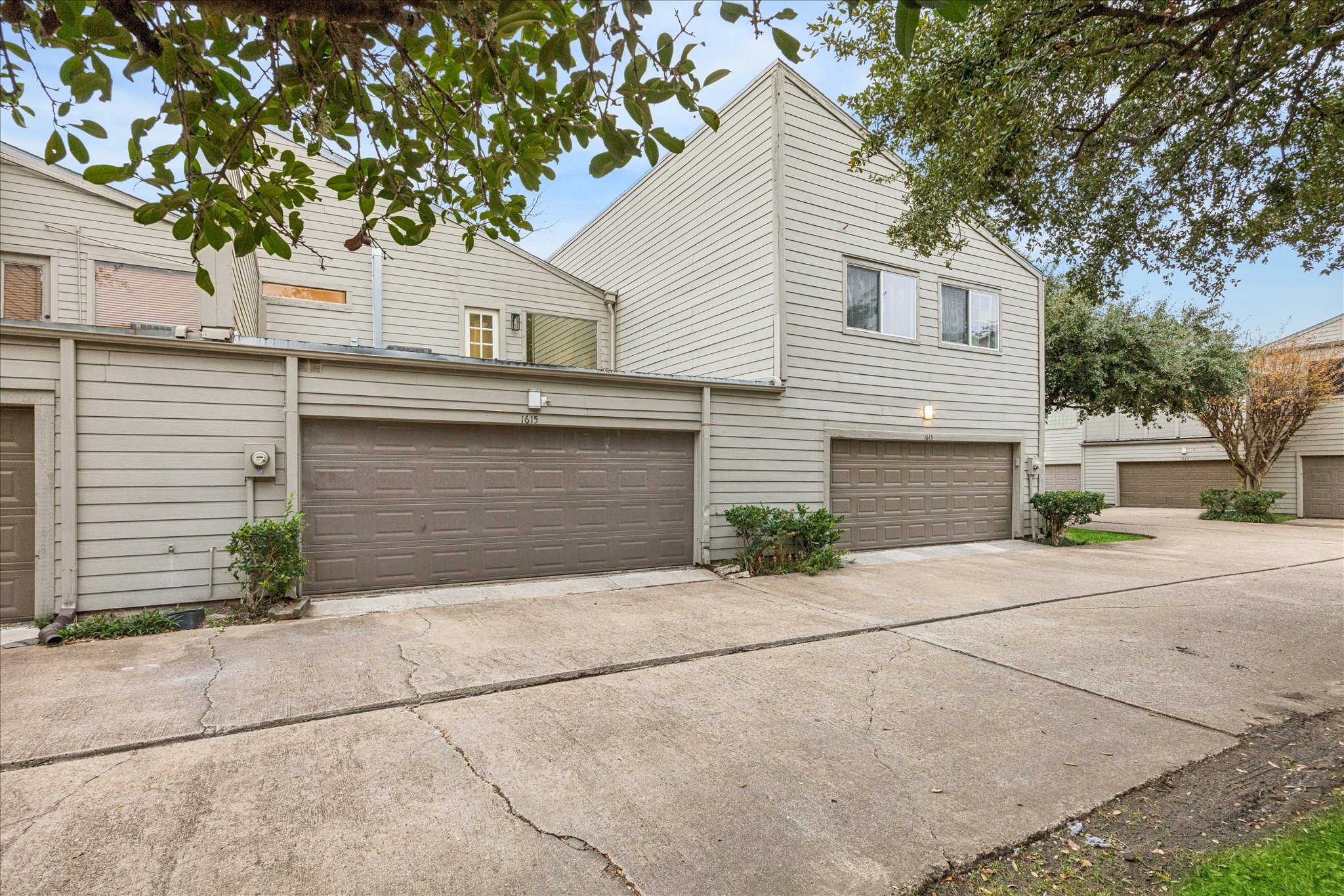 1615 Prairie Mark Lane Houston, TX 77077 - Photo 21 of 25 And looking from the little park behind to the 2 car garage. Rooftop deck above. There is extra storage space inside the garage on the right side. Sellers love their neighbors!!! And the quietness.