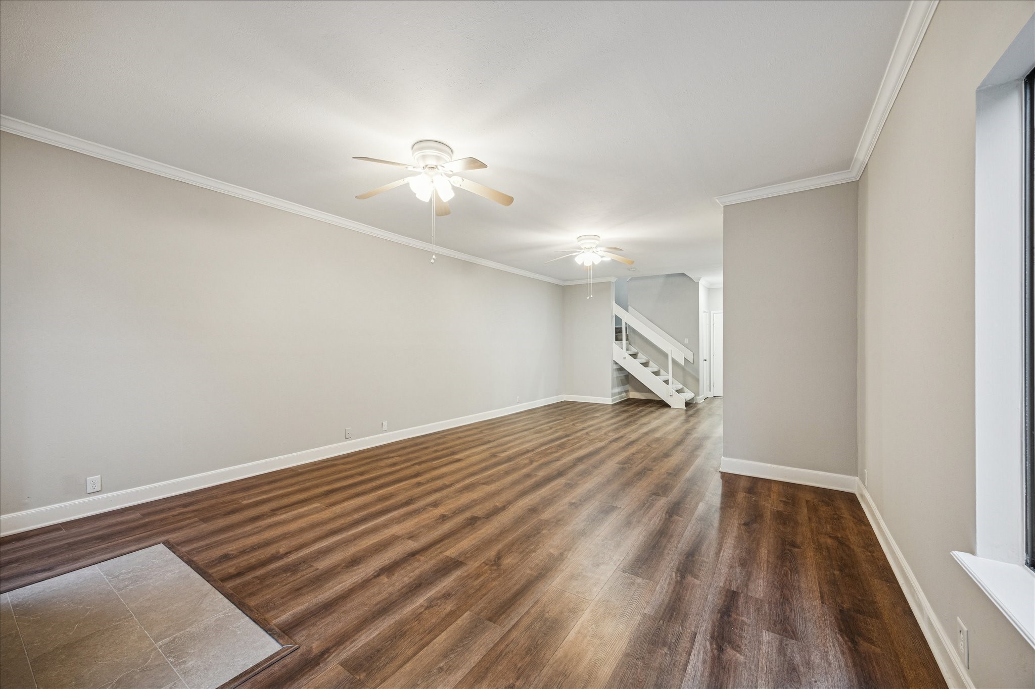 1615 Prairie Mark Lane Houston, TX 77077 - Photo 4 of 25 One you step inside the front door you see this view. Gorgeous luxury vinyl plank flooring, crown molding, high ceilings & ceiling fans to keep you cool. There is a fireplace to the right where you see the square tiles.