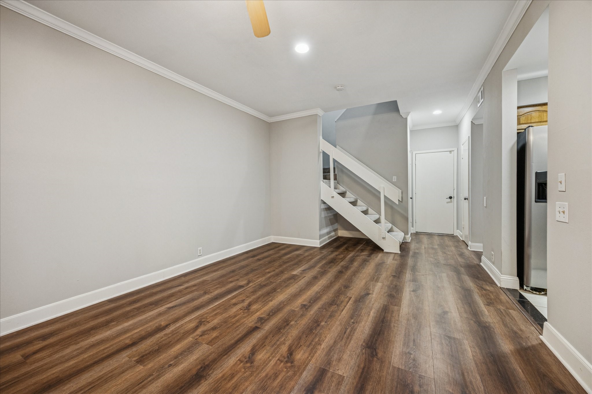 1615 Prairie Mark Lane Houston, TX 77077 - Photo 5 of 25 Another view upon entering. There are 2 windows behind on either side of the fireplace, and one to the right that you cannot see in this photo. So good natural lighting inside. The kitchen is to the right, and just past that is the utility room and half bath. The door straight ahead leads to the 2 car oversized garage. On either side of the door leading to the garage are storage closets. One is a linen closet, the other under the stairs is huge!