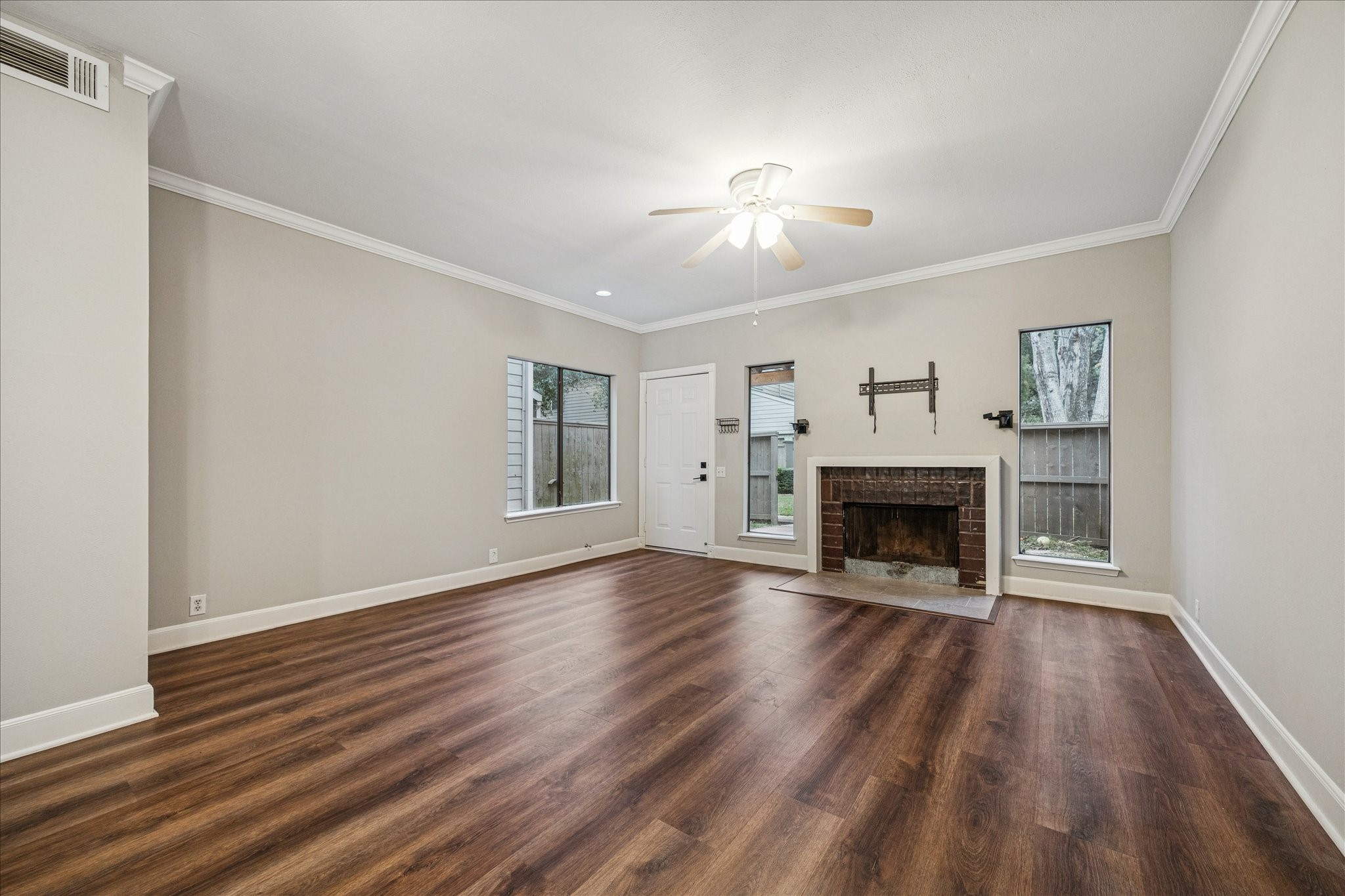 1615 Prairie Mark Lane Houston, TX 77077 - Photo 6 of 25 This view is looking back to the front door. Cozy wood burning fireplace. Through the windows you can see the front patio. Just past the fence is the huge courtyard.