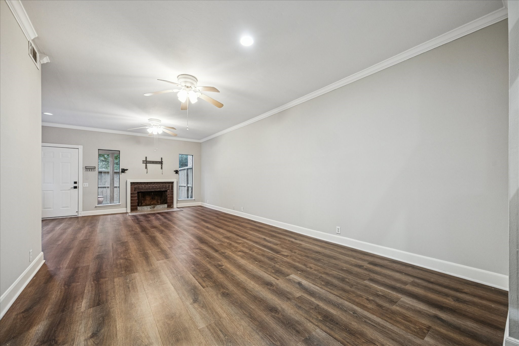 1615 Prairie Mark Lane Houston, TX 77077 - Photo 7 of 25 And another view. This long wall on the right had foundation work done in 2024, and has a warranty. The interior was painted in 2026. Universal mount for a TV, as well as speaker mounts above the fireplace.