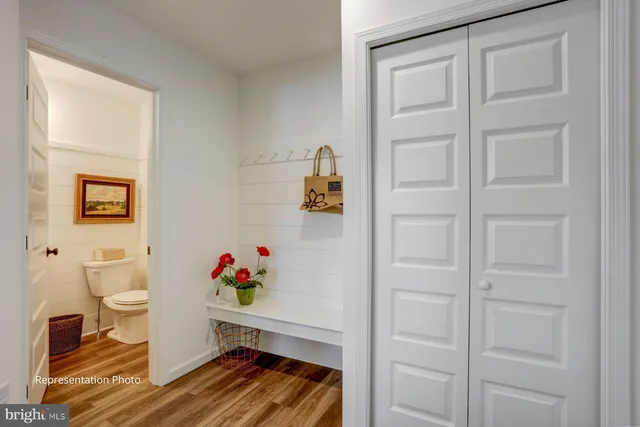 a living room with a baby crib furniture and a toilet