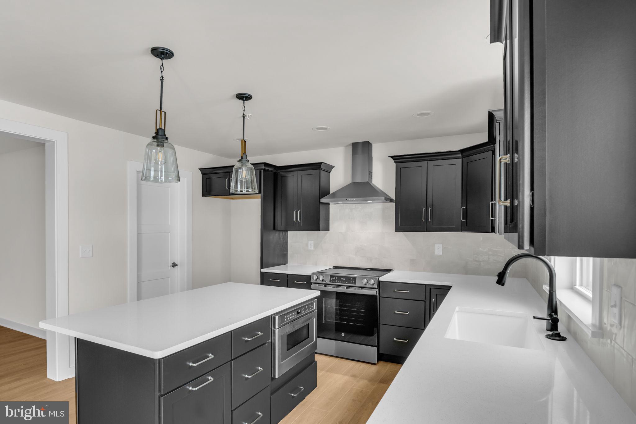 1012 Blackstone Run Carlisle, PA 17015 - Photo 2 of 13 a kitchen with stainless steel appliances a stove a sink and white cabinets