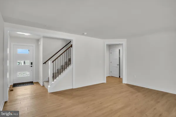 a view of an entryway with wooden floor