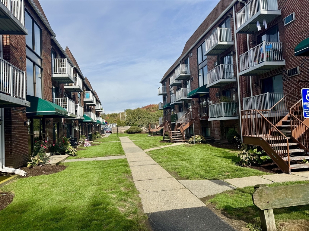 a view of yard with tall buildings and a yard
