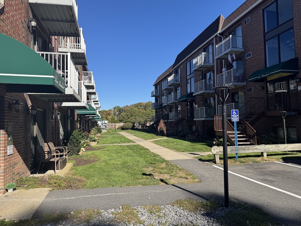 1186 Worcester Road, Unit 720 Framingham, MA 01702 - Photo 13 of 15 a street sign on a sidewalk next to a building