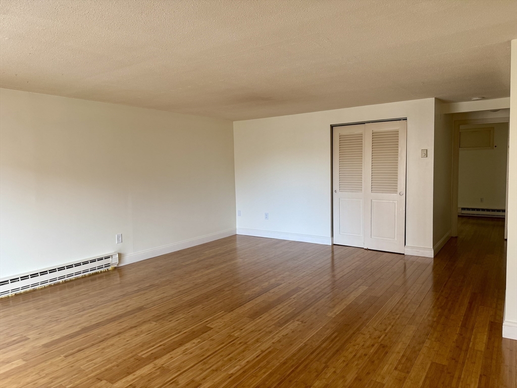 1186 Worcester Road, Unit 720 Framingham, MA 01702 - Photo 5 of 15 a view of an empty room and wooden floor