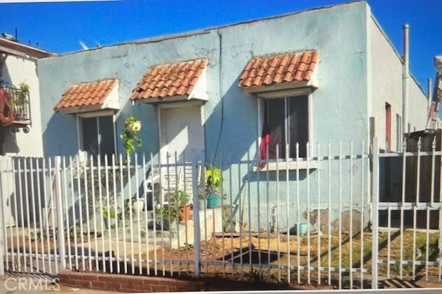 a view of a brick house with a small yard