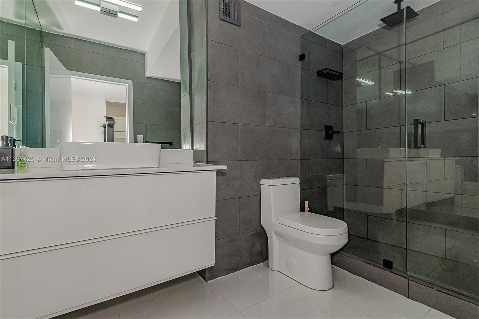 100 Lincoln Road, Unit 519 Miami Beach, FL 33139 - Photo 12 of 15 a bathroom with a sink toilet and shower