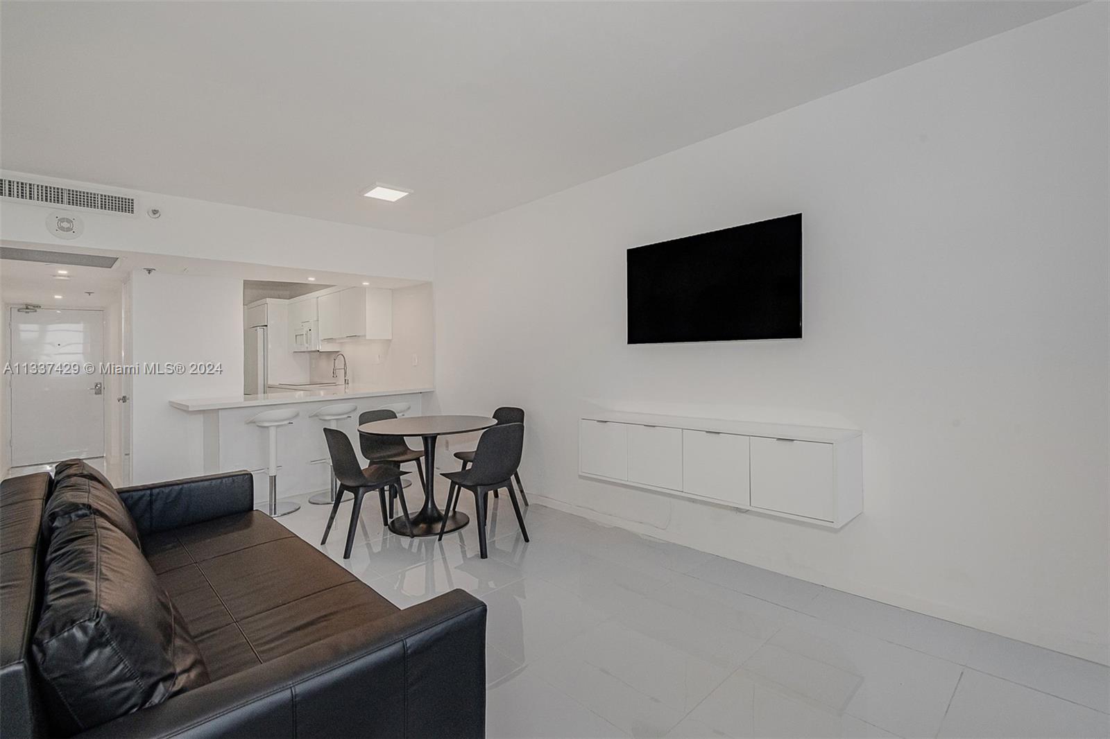 100 Lincoln Road, Unit 519 Miami Beach, FL 33139 - Photo 5 of 15 a living room with furniture and a flat screen tv