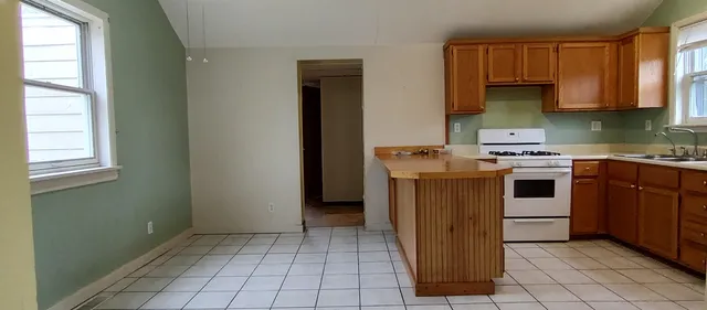 a kitchen with a stove sink and cabinets