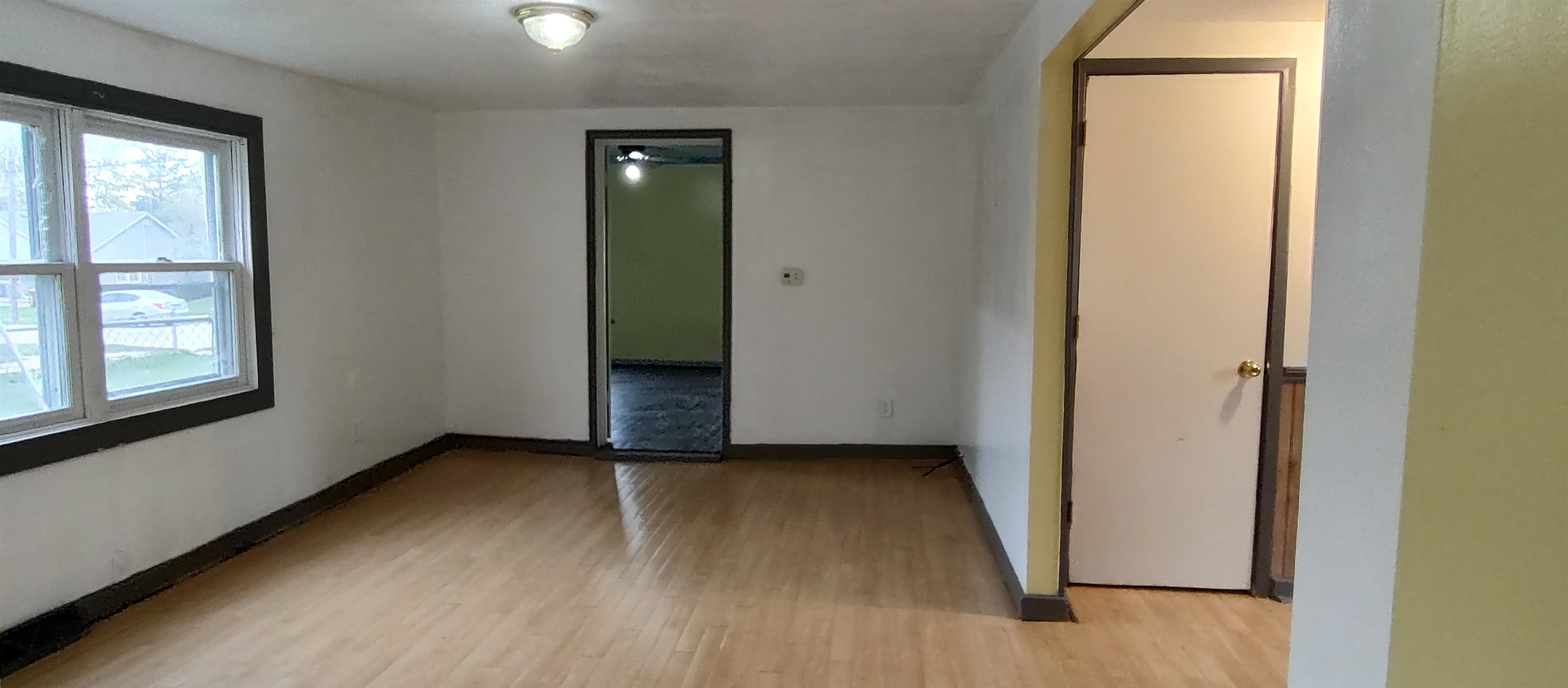 1027 Garfield Avenue Belvidere, IL 61008 - Photo 16 of 21 an empty room with wooden floor and windows