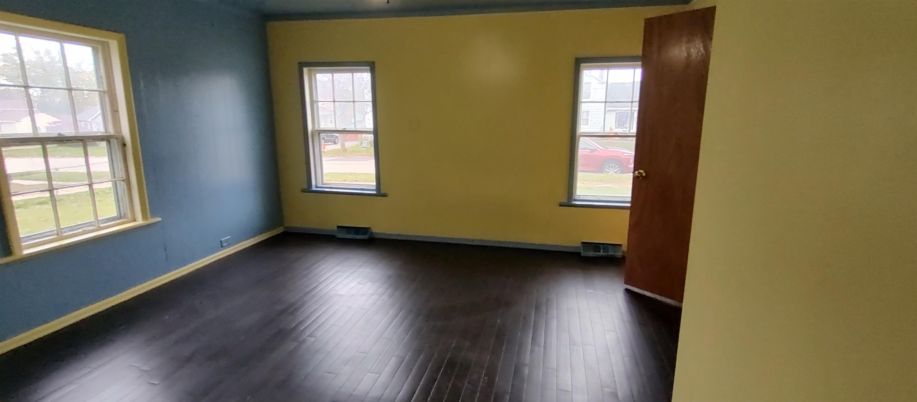 1027 Garfield Avenue Belvidere, IL 61008 - Photo 17 of 21 an empty room with wooden floor and windows