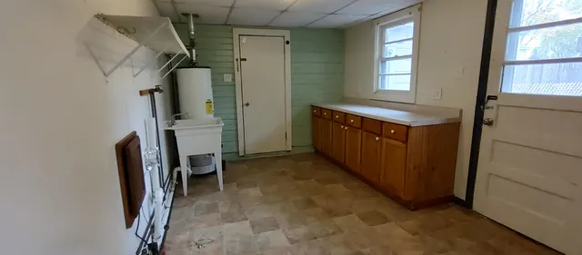 a view of walk in closet with window and bathroom