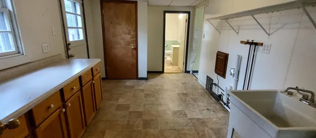 a bathroom with a tub sink and mirror