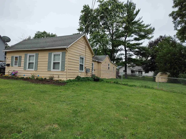 a front view of house with yard and green space