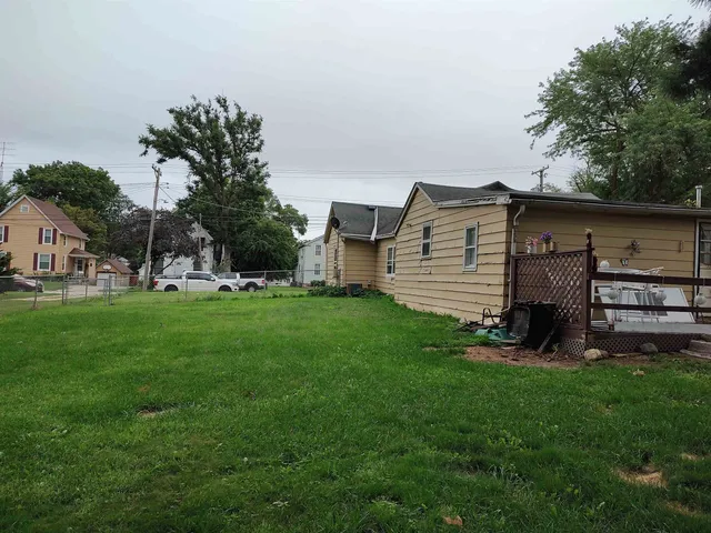 a view of a house with a yard and sitting area