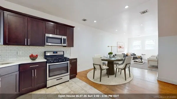 a kitchen with wooden cabinets and a stove top oven