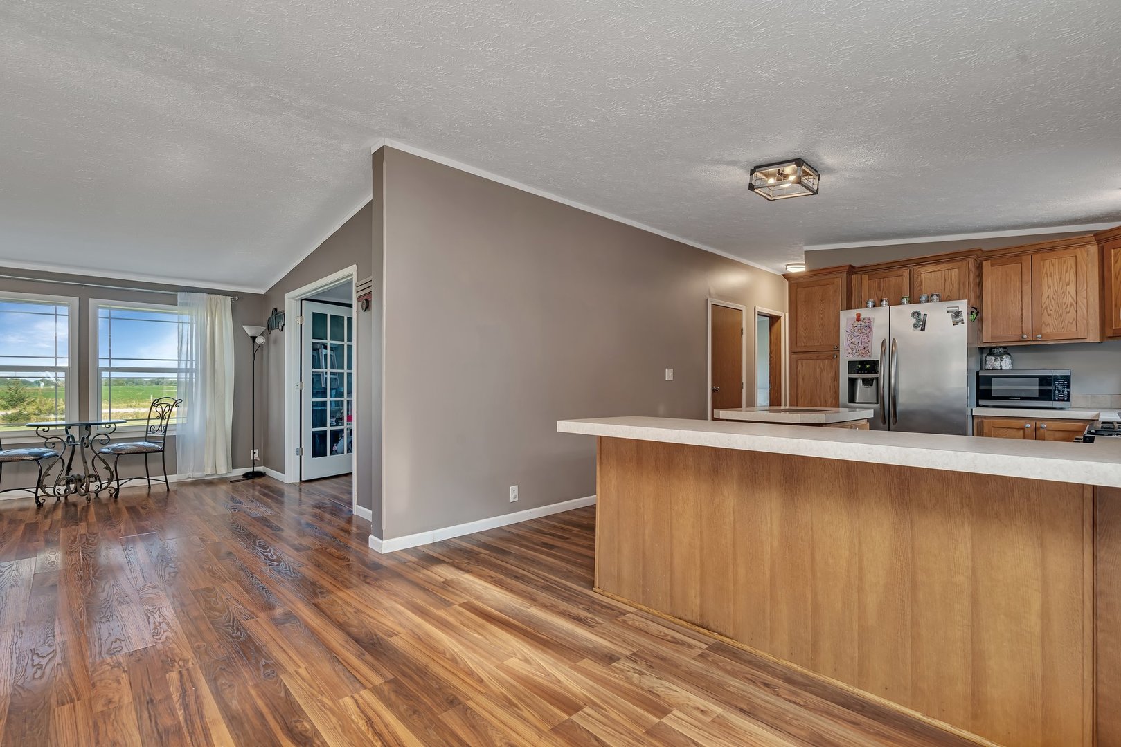 2389 East 29th Road Seneca, IL 61360 - Photo 11 of 46 a living room with stainless steel appliances wooden floors and large window