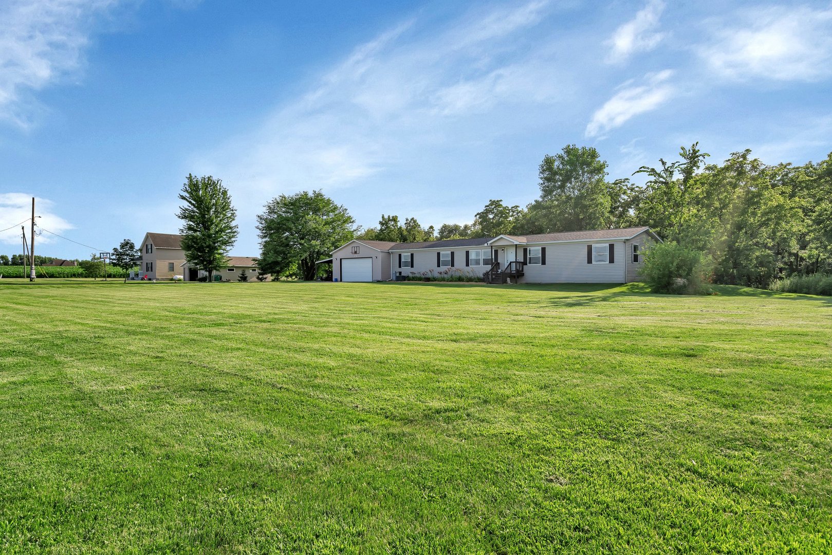 2389 East 29th Road Seneca, IL 61360 - Photo 5 of 46 a view of a big yard with a house in the background