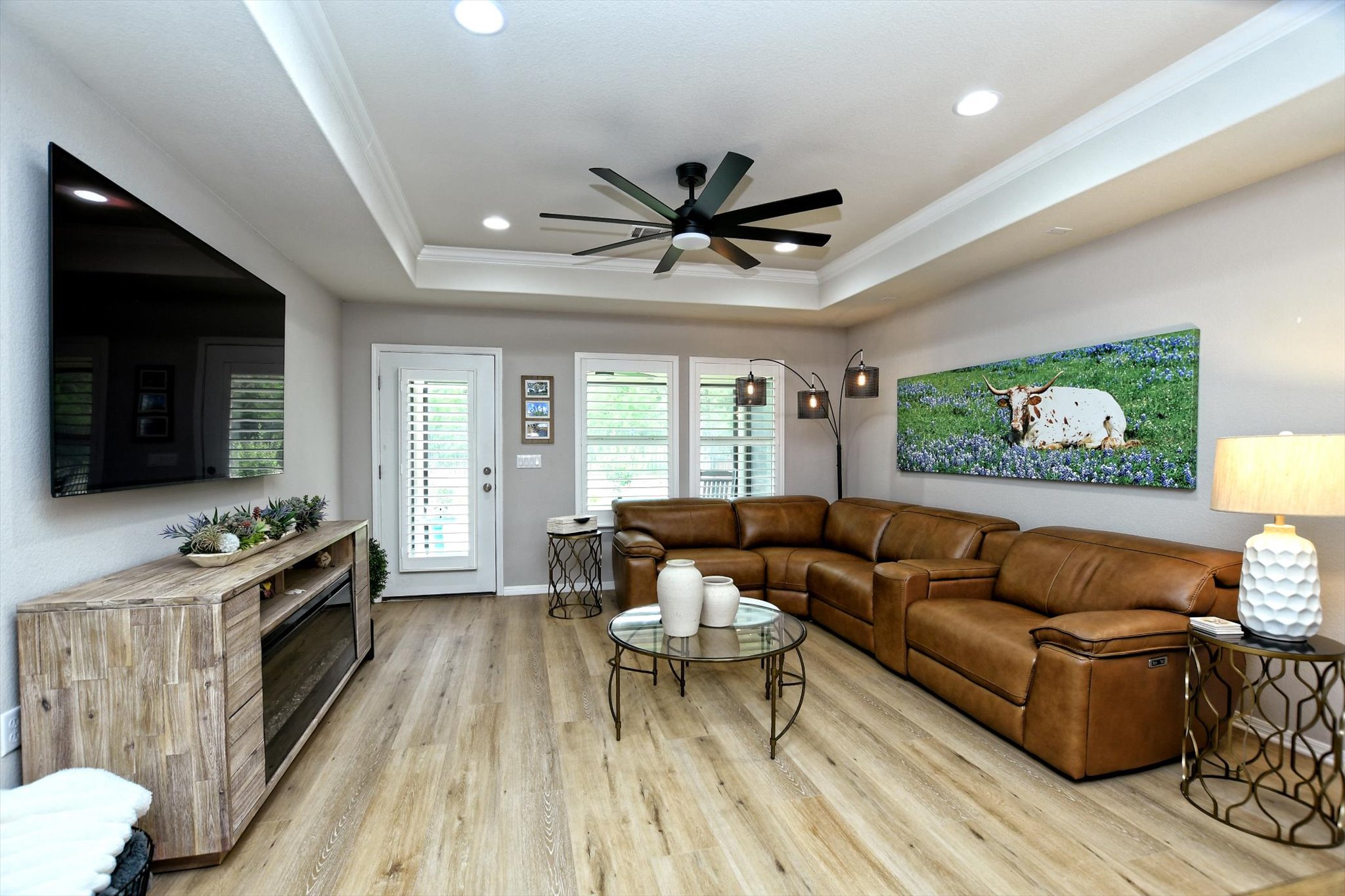 231 Hobby Street Georgetown, TX 78633 - Photo 5 of 29 A comfortable living area with light wood flooring and a modern ceiling fan for optimal airflow.