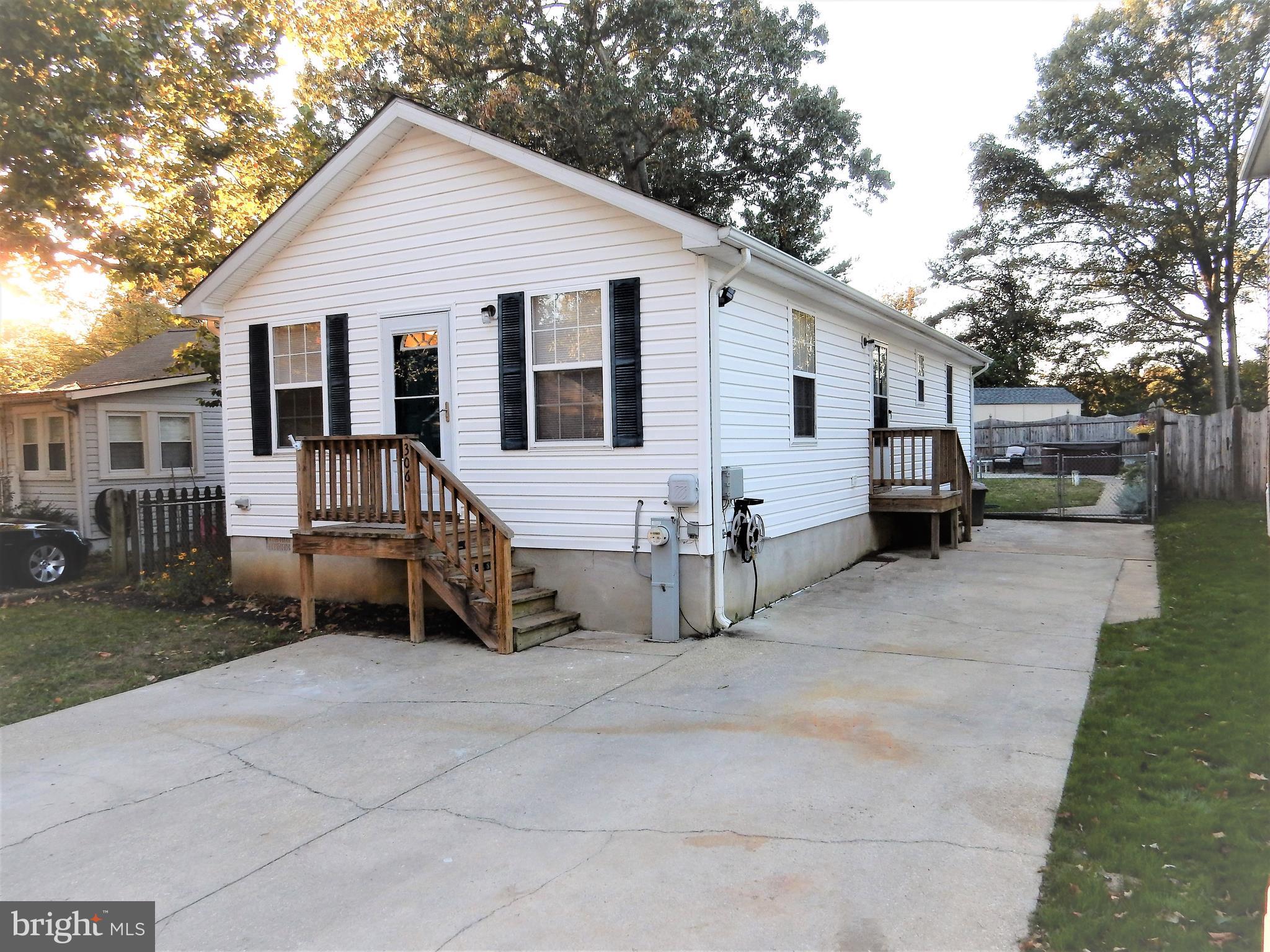 306 Oakwood Road Edgewater, MD 21037 - Photo 1 of 36 a view of a house with a yard and wooden fence