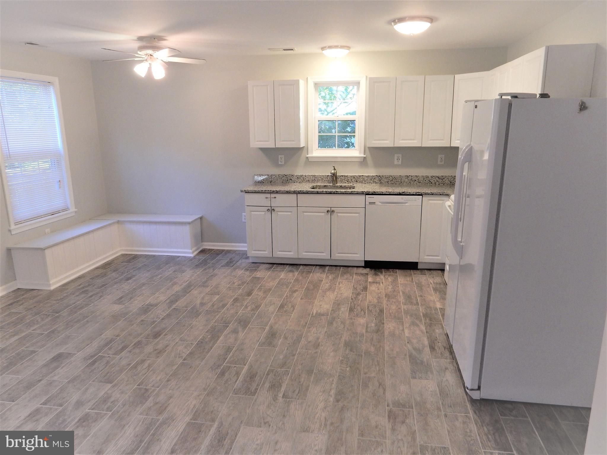 306 Oakwood Road Edgewater, MD 21037 - Photo 3 of 36 a kitchen with a refrigerator a sink and a window