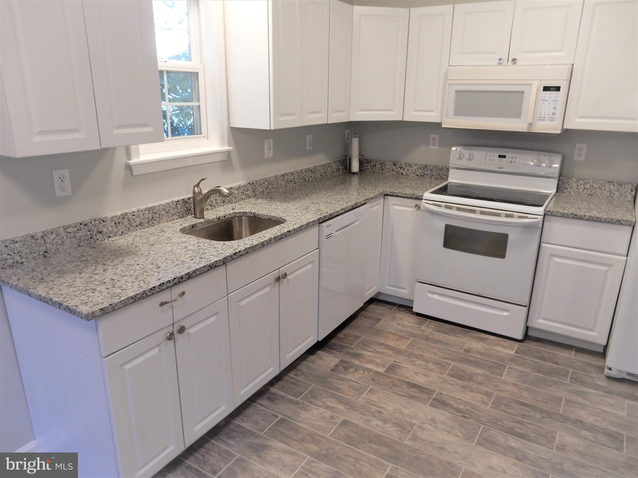 306 Oakwood Road Edgewater, MD 21037 - Photo 4 of 36 a kitchen with granite countertop a sink and cabinets
