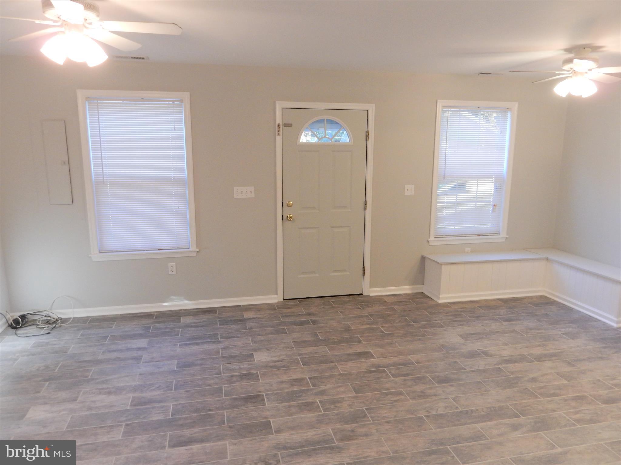 306 Oakwood Road Edgewater, MD 21037 - Photo 36 of 36 a view of an empty room with window and hardwood floor
