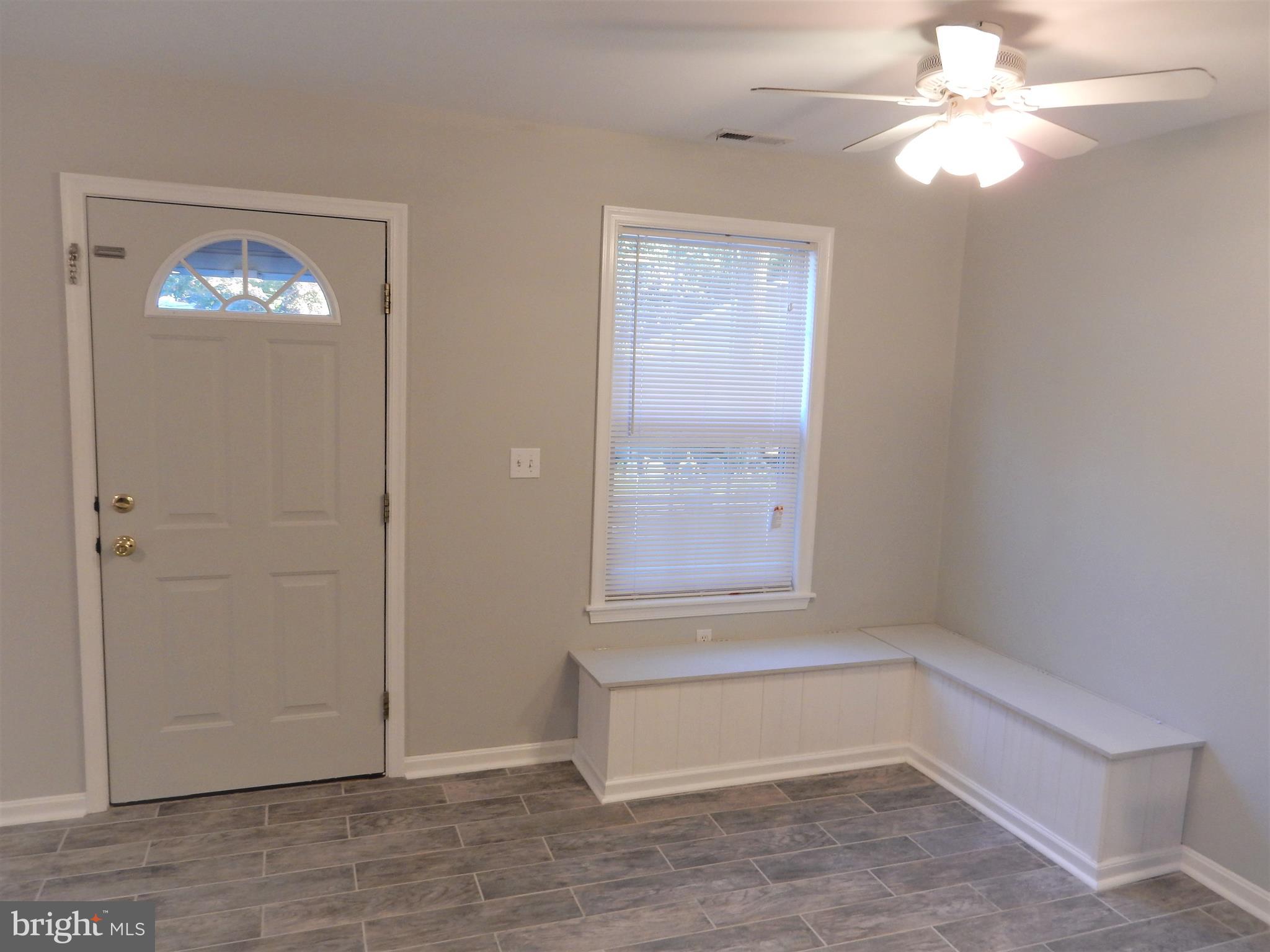 306 Oakwood Road Edgewater, MD 21037 - Photo 6 of 36 wooden floor in an empty room with a window