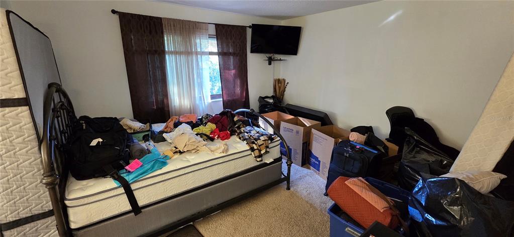 165 Pine Cone Trail Ormond Beach, FL 32174 - Photo 17 of 25 a bedroom with furniture and a flat screen tv