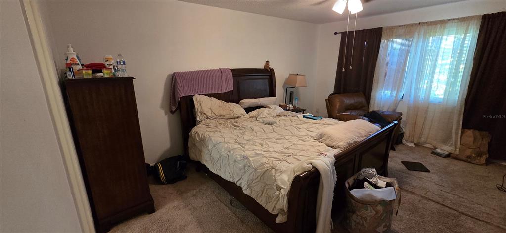 165 Pine Cone Trail Ormond Beach, FL 32174 - Photo 21 of 25 a bed sitting in a bedroom next to a window