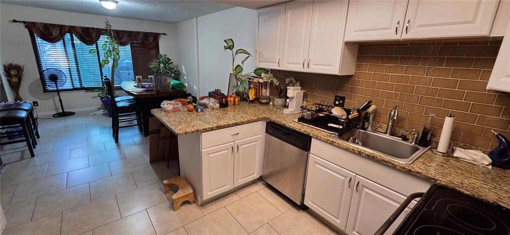165 Pine Cone Trail Ormond Beach, FL 32174 - Photo 9 of 25 a kitchen with a sink appliances and cabinets
