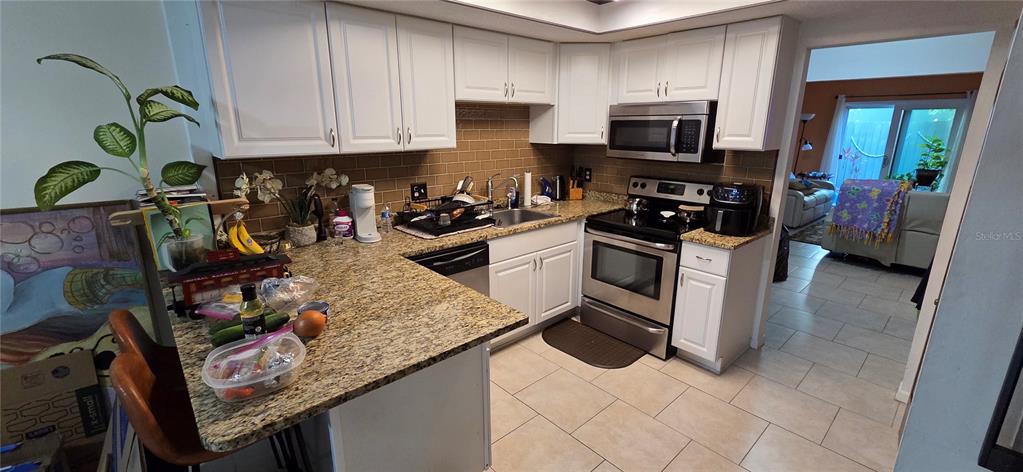 165 Pine Cone Trail Ormond Beach, FL 32174 - Photo 10 of 25 a kitchen with a sink a stove and cabinets