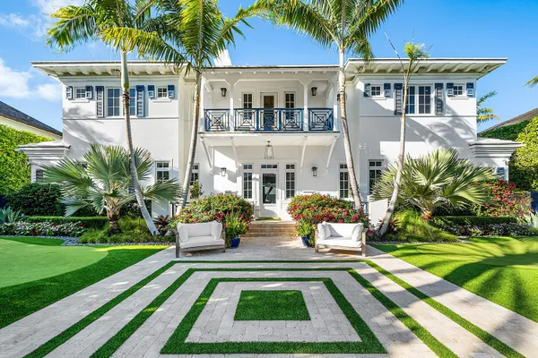 a view of a house with backyard porch and sitting area
