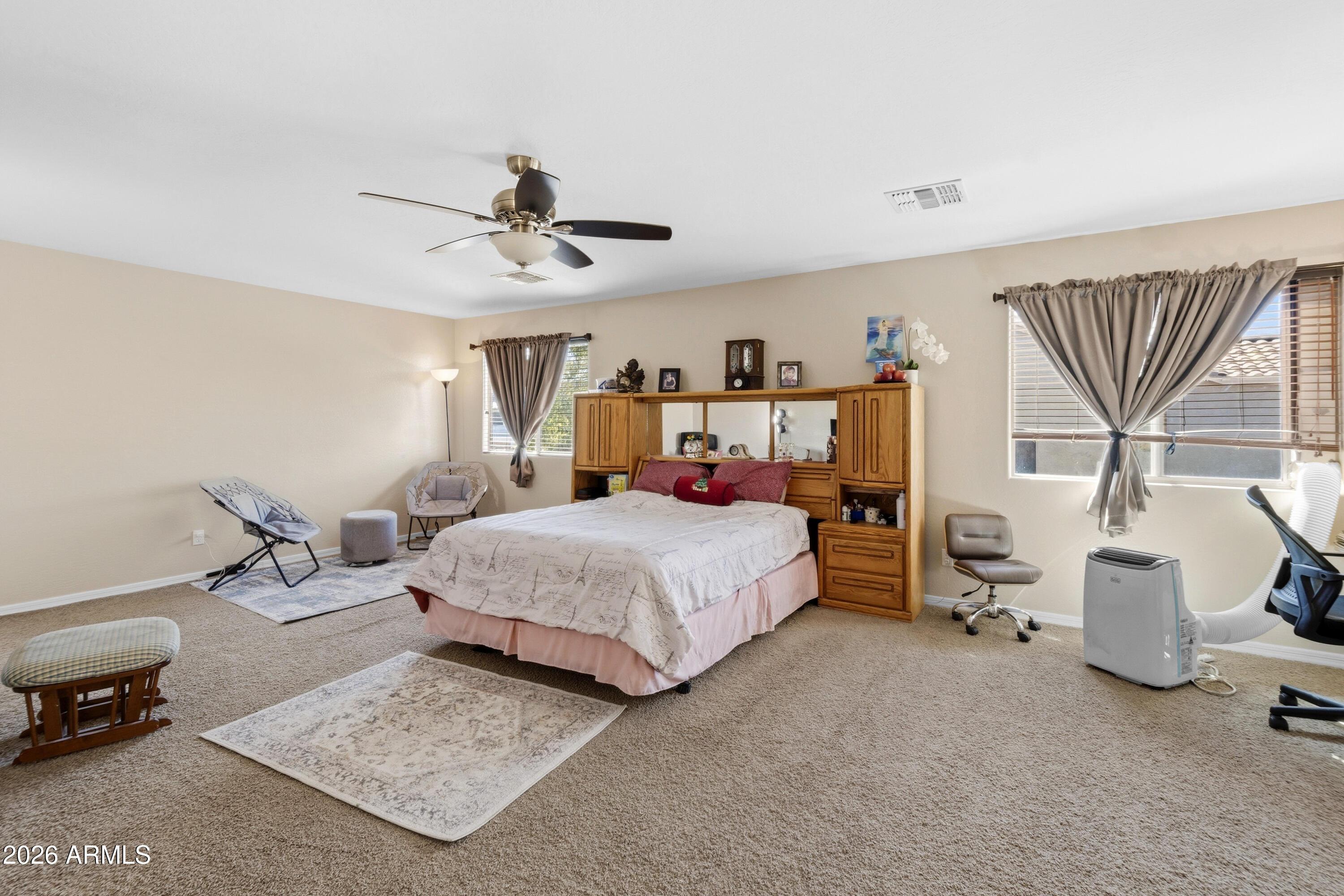 7639 West Georgetown Way Florence, AZ 85132 - Photo 12 of 25 a bedroom with a bed and a chandelier