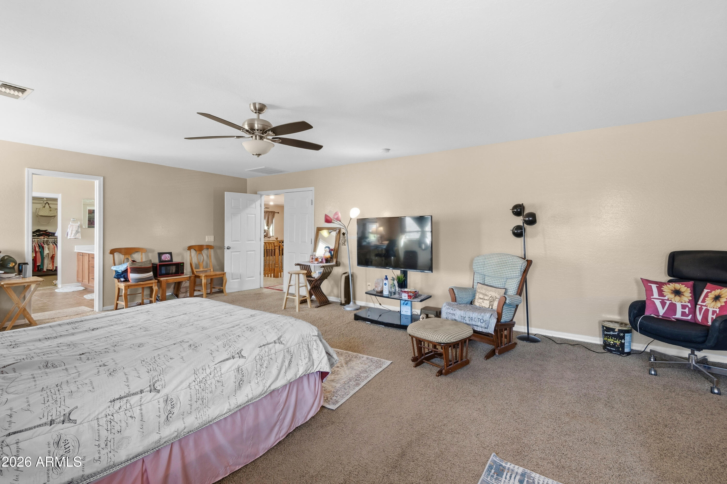 7639 West Georgetown Way Florence, AZ 85132 - Photo 13 of 25 a bedroom with furniture a bed and a chandelier