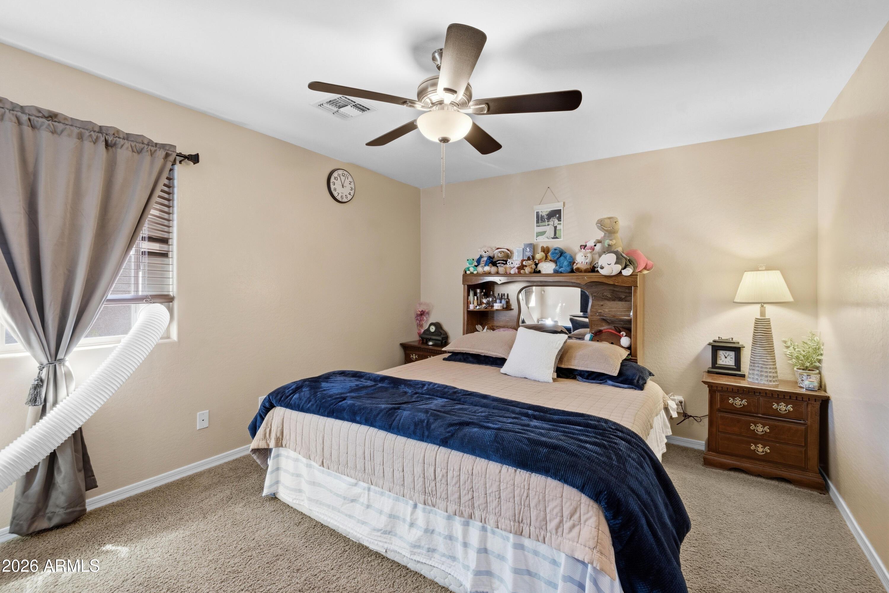 7639 West Georgetown Way Florence, AZ 85132 - Photo 19 of 25 a bedroom with a bed and a chandelier