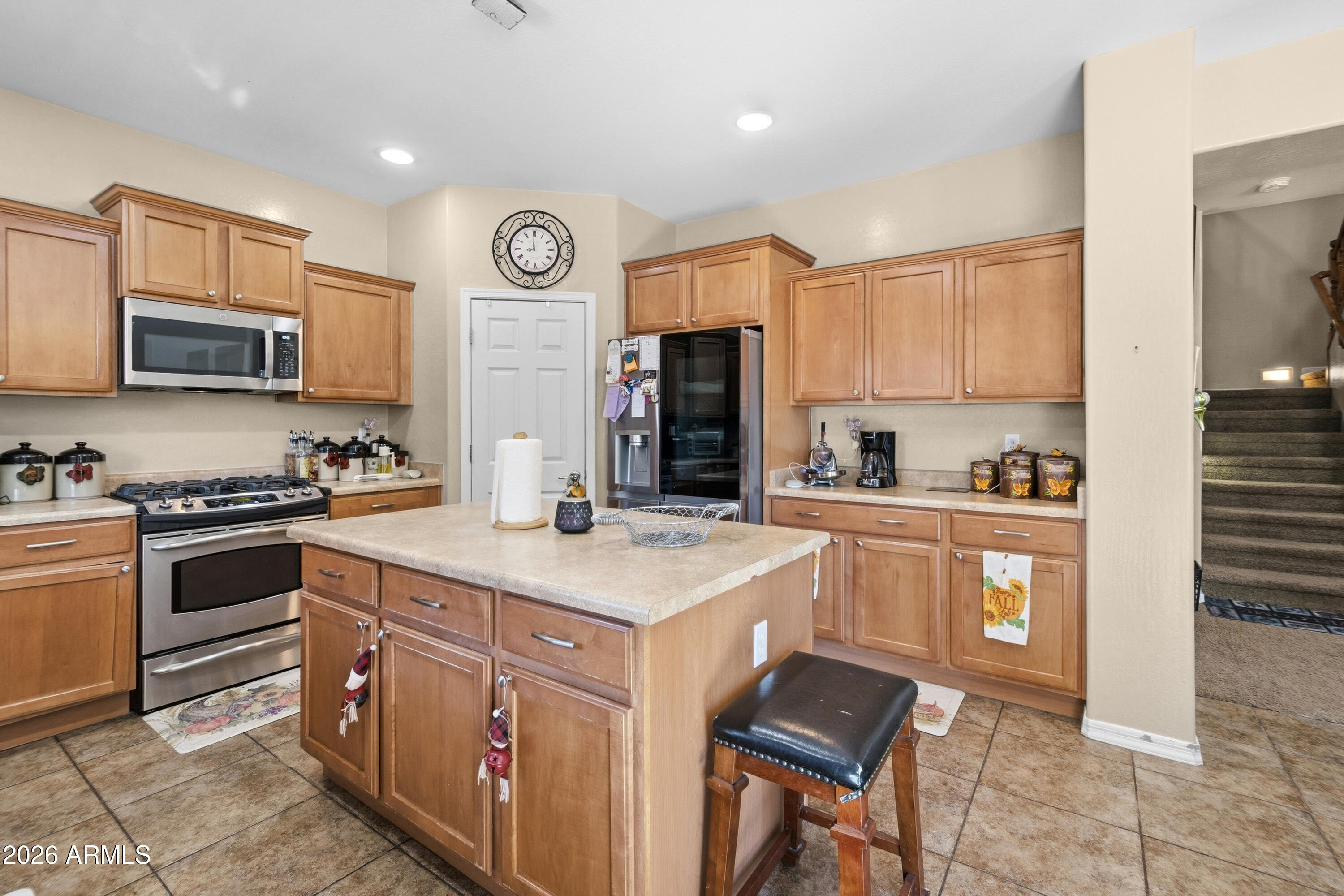 7639 West Georgetown Way Florence, AZ 85132 - Photo 4 of 25 a kitchen with stainless steel appliances granite countertop a stove top oven a sink dishwasher and a refrigerator with wooden cabinets