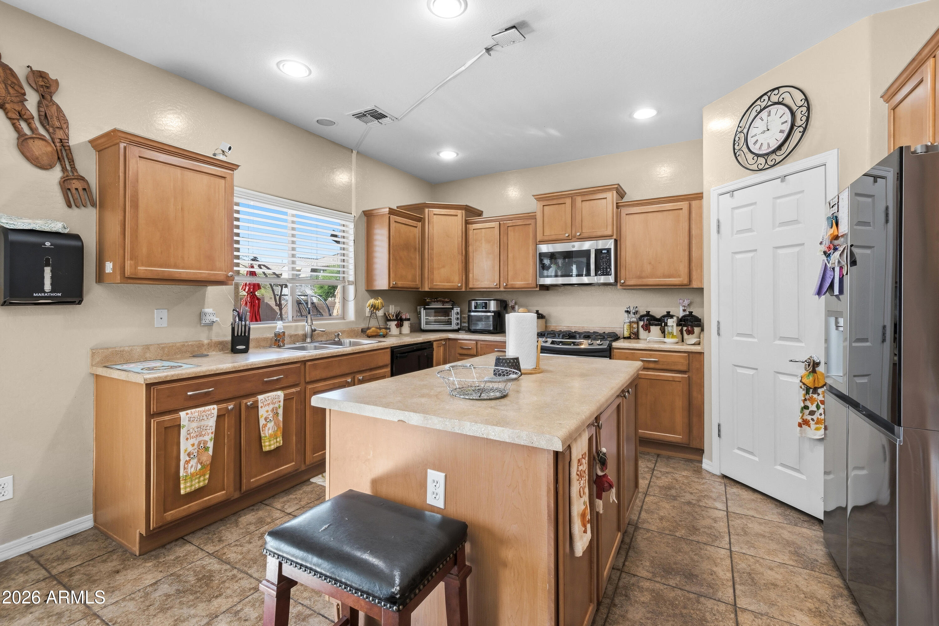 7639 West Georgetown Way Florence, AZ 85132 - Photo 6 of 25 a kitchen with a sink a stove a refrigerator cabinets and a dining table
