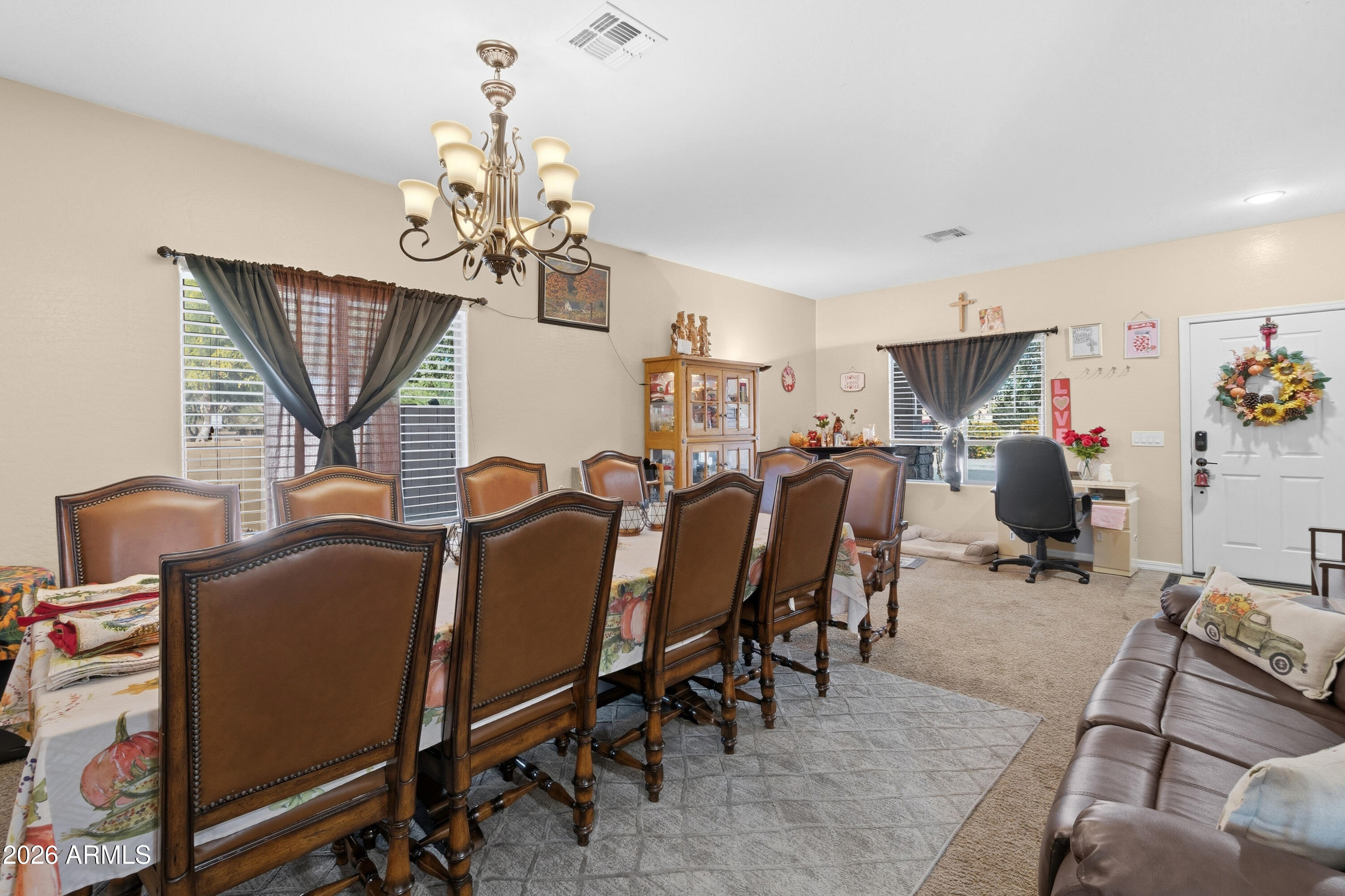 7639 West Georgetown Way Florence, AZ 85132 - Photo 7 of 25 a view of a dining room with furniture and a chandelier