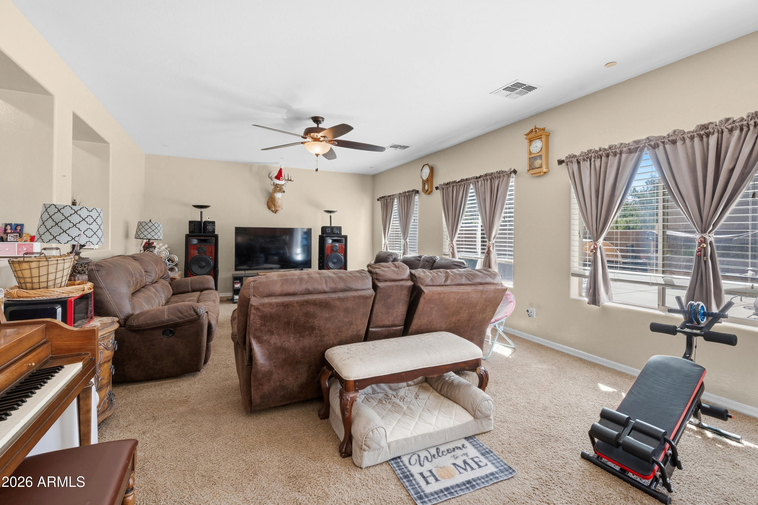 7639 West Georgetown Way Florence, AZ 85132 - Photo 8 of 25 a living room with furniture a fireplace and a large window