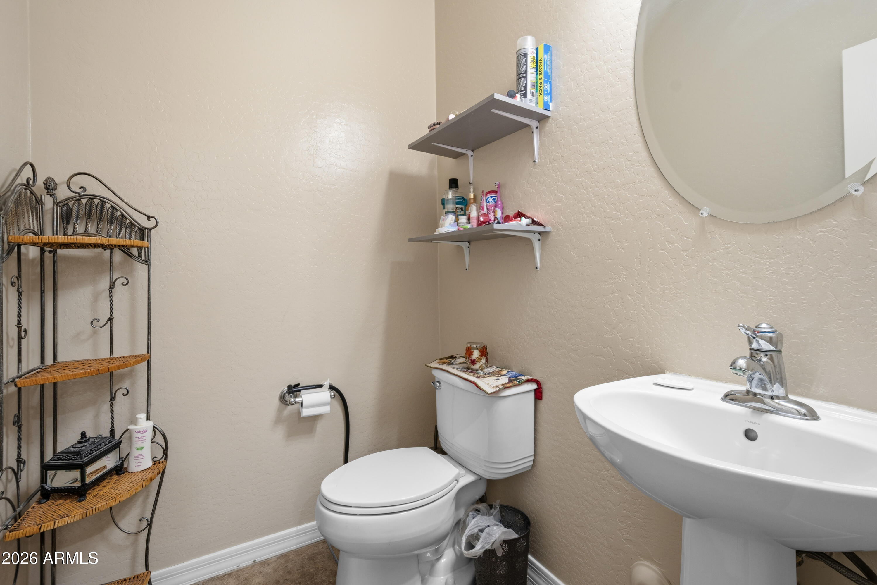 7639 West Georgetown Way Florence, AZ 85132 - Photo 9 of 25 a bathroom with a toilet sink and mirror
