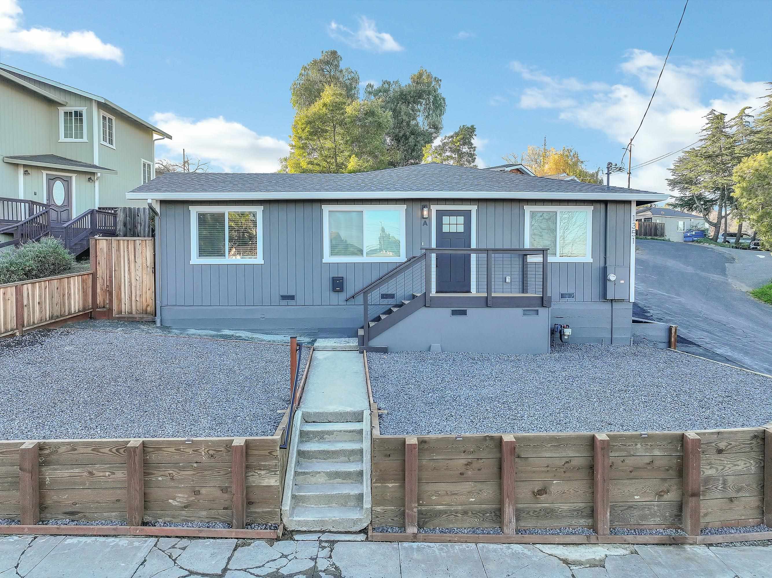 View of front of house featuring a shingled roof, stairs, and crawl space