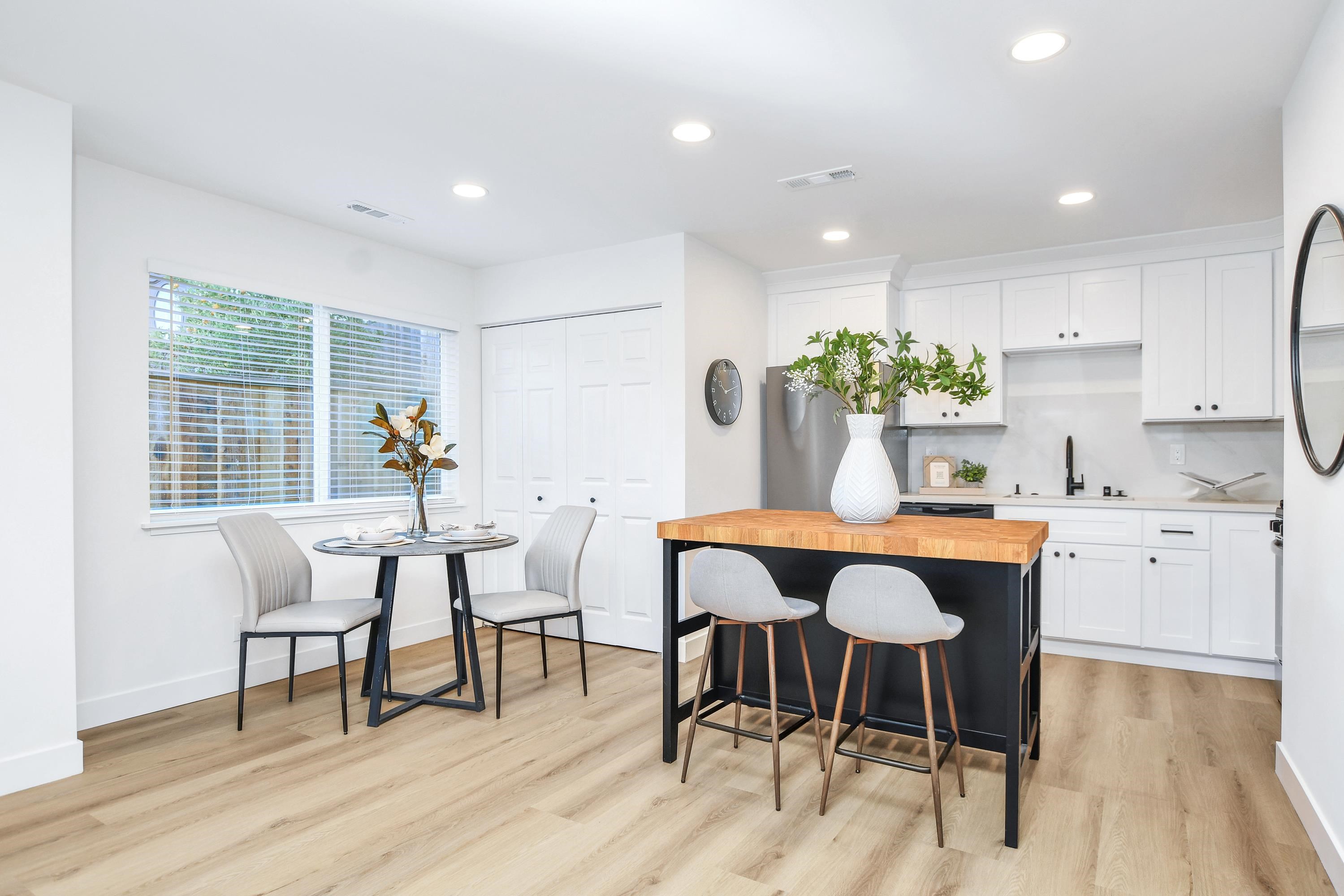 1351 Shell Avenue Martinez, CA 94553 - Photo 7 of 29 Kitchen featuring white cabinetry, recessed lighting, wood counters, a center island, and a kitchen bar