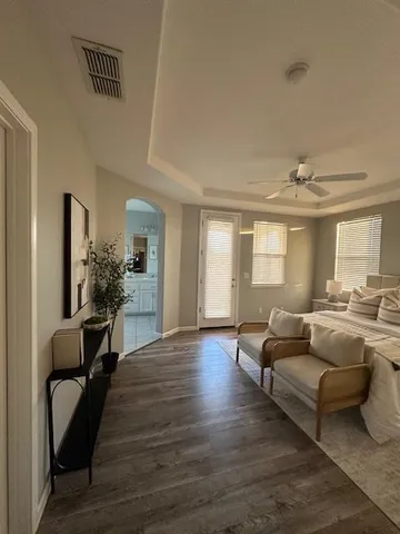a living room with furniture and a wooden floor