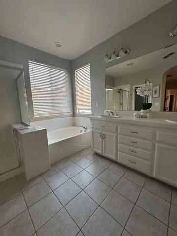 a bathroom with a bathtub sink and mirror