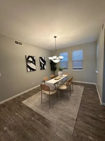 a living room with a couch and a wooden floor