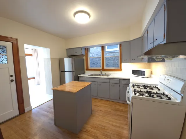 a kitchen with stainless steel appliances granite countertop a refrigerator stove sink and cabinets